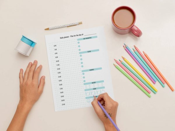 Woman planning productive day with daily planner